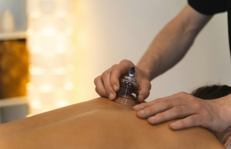 Eine Person erhält eine Schröpfmassage auf dem Rücken.
